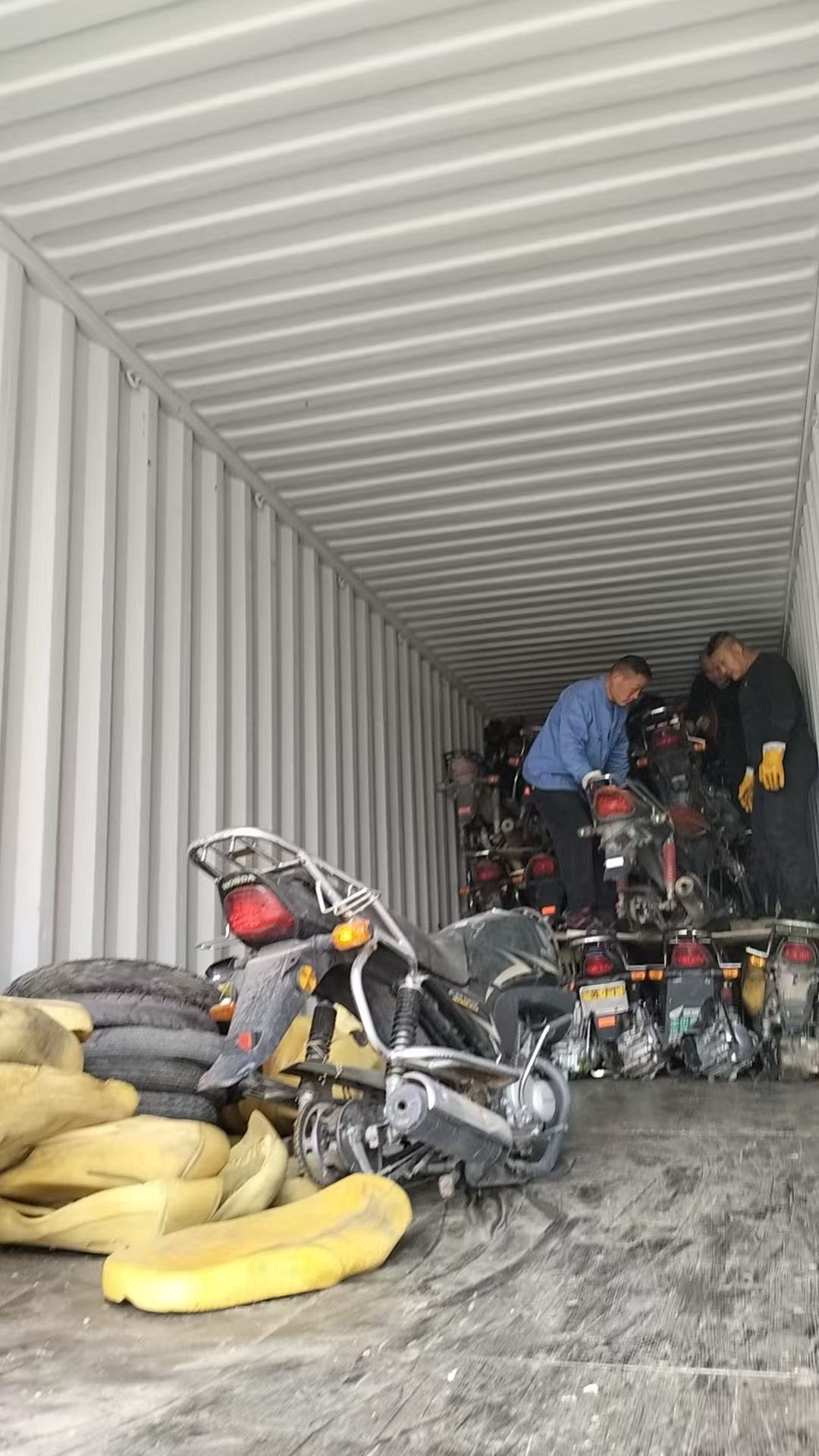 A full container load of motorcycles packed floor to ceiling by the loading crew